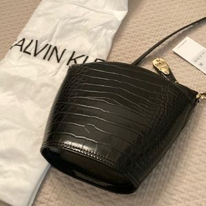 NWT Calvin Klein black cross “bucket” design body purse w/ purse cover bag.